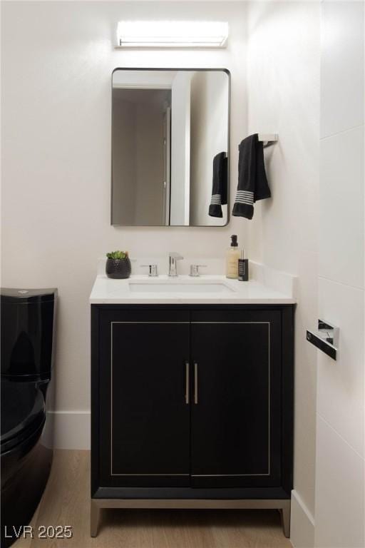 bathroom with baseboards and vanity