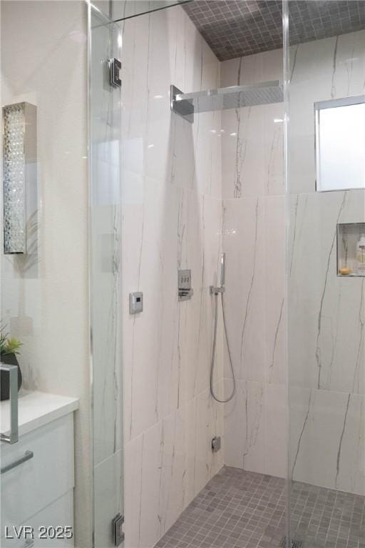 full bathroom with vanity and a marble finish shower