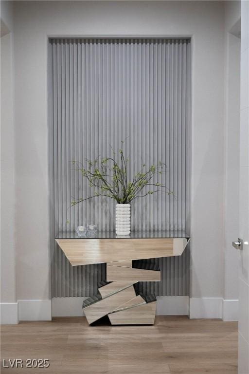 interior details with baseboards and wood finished floors