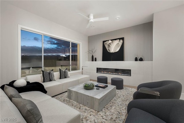 living room featuring recessed lighting, a glass covered fireplace, and ceiling fan