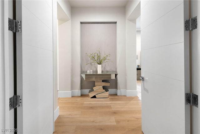 hallway with baseboards and wood finished floors
