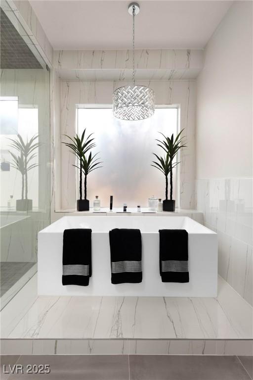 interior space featuring a marble finish shower