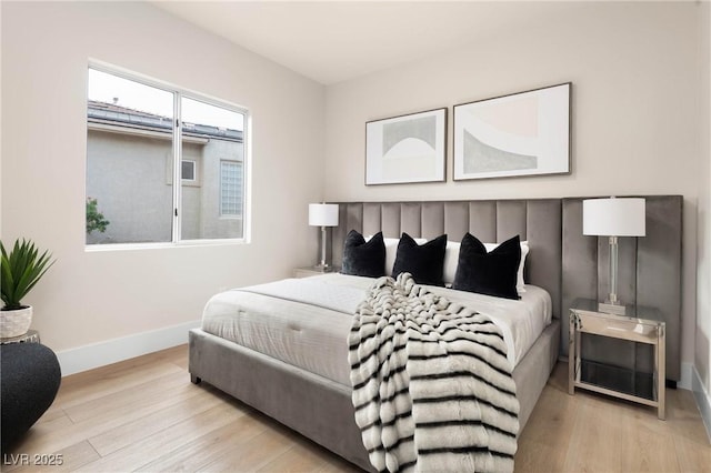 bedroom with baseboards and wood finished floors