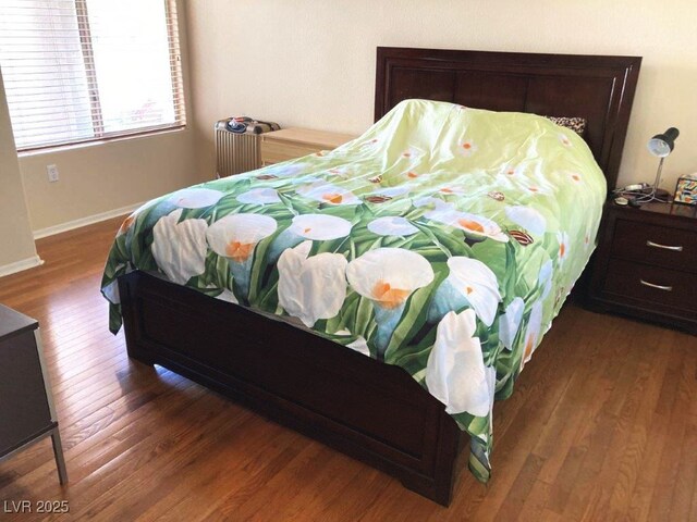bedroom featuring baseboards and wood finished floors