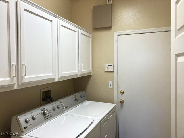 washroom featuring washing machine and dryer and cabinet space