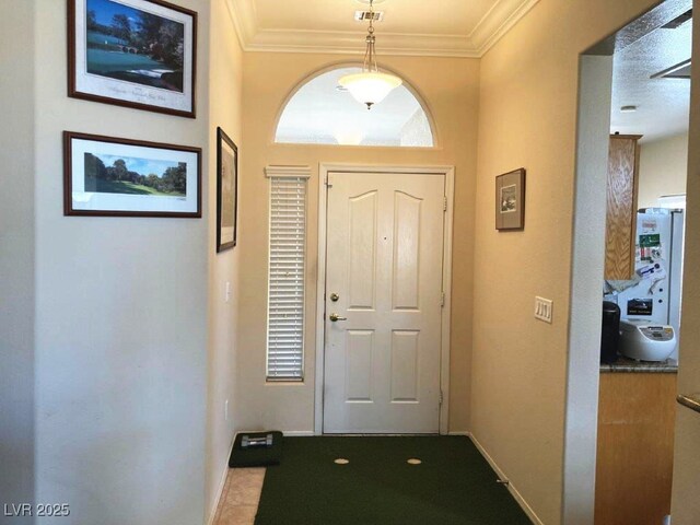 entryway with visible vents, crown molding, and baseboards
