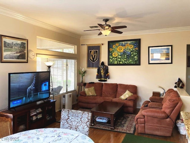living room featuring visible vents, a ceiling fan, wood finished floors, and ornamental molding