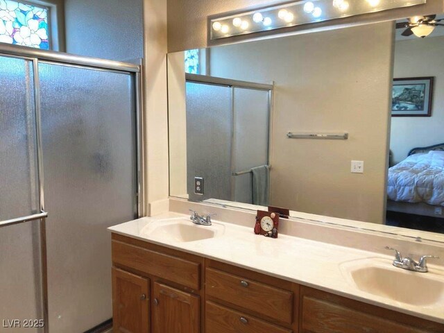 ensuite bathroom featuring ensuite bath, a shower with shower door, a sink, and double vanity