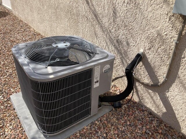 exterior details featuring cooling unit and stucco siding