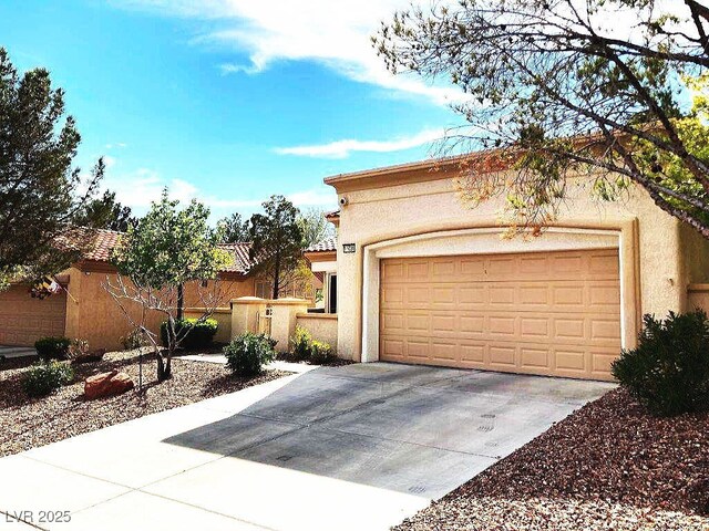 view of front facade with stucco siding and an attached garage