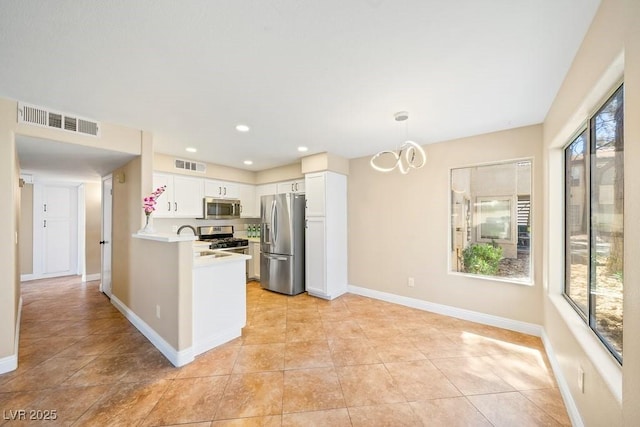 3123 Key Largo Dr Unit 101, Las Vegas, NV 89120 - kitchen featuring stainless steel appliances, white cabinetry, light countertops, baseboards, and light tile patterned floors