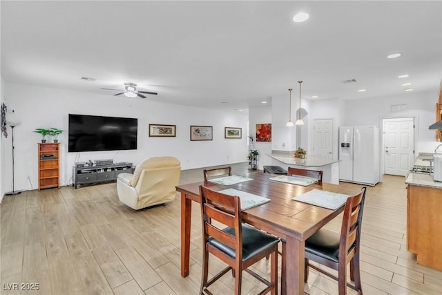 dining area featuring a ceiling fan, light wood-style floors, and recessed lighting