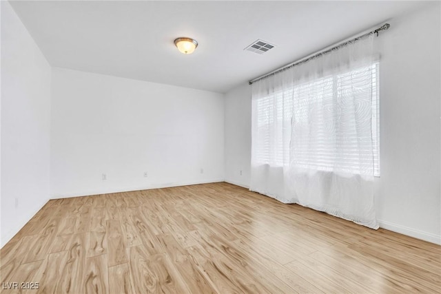 empty room featuring wood finished floors and baseboards