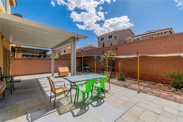 view of patio with outdoor dining area and a fenced backyard