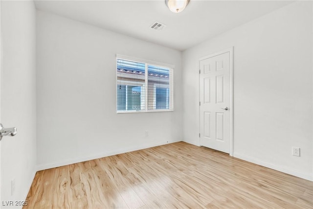 unfurnished room with wood finished floors and baseboards