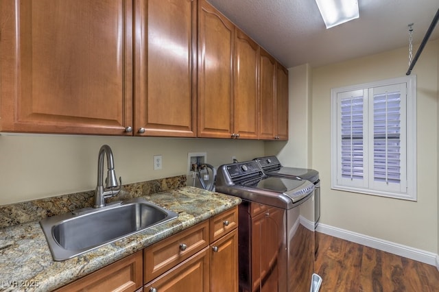 8429 Brackenfield Ave, Las Vegas, NV 89178 - washroom with washing machine and dryer, baseboards, cabinet space, and dark wood-style flooring