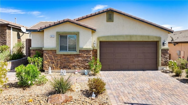 2612 Tullamore Creek Ln, Laughlin, NV 89029 - view of front of property with stone siding, stucco siding, a garage, decorative driveway, and a tiled roof