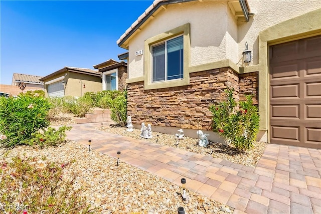 2612 Tullamore Creek Ln, Laughlin, NV 89029 - doorway to property featuring stucco siding, stone siding, and a tile roof