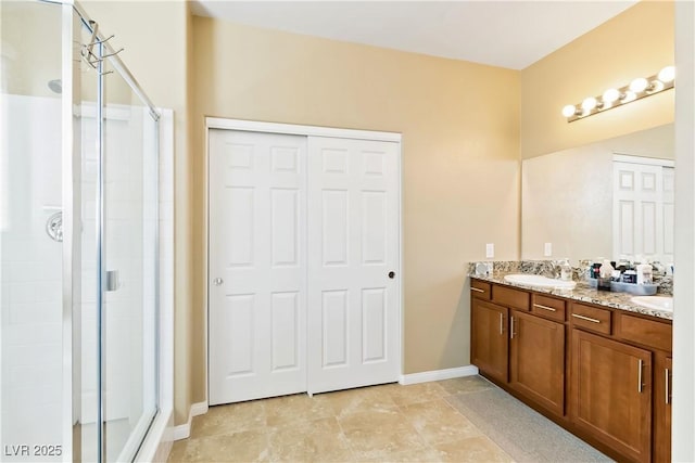2612 Tullamore Creek Ln, Laughlin, NV 89029 - bathroom featuring a stall shower, double vanity, and baseboards