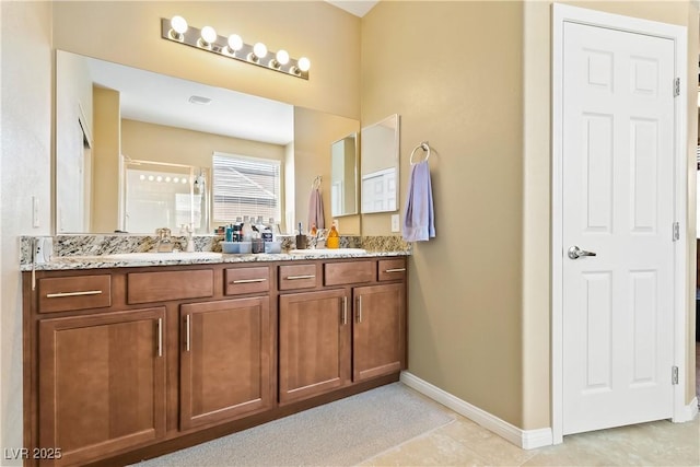 2612 Tullamore Creek Ln, Laughlin, NV 89029 - bathroom with baseboards, a stall shower, and double vanity