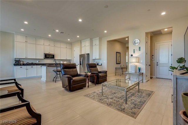 8944 Skye Canyon Ranch St, Las Vegas, NV 89166 - living room featuring baseboards, recessed lighting, and light tile patterned flooring