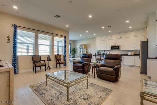 8944 Skye Canyon Ranch St, Las Vegas, NV 89166 - living room with recessed lighting, light tile patterned floors, and baseboards
