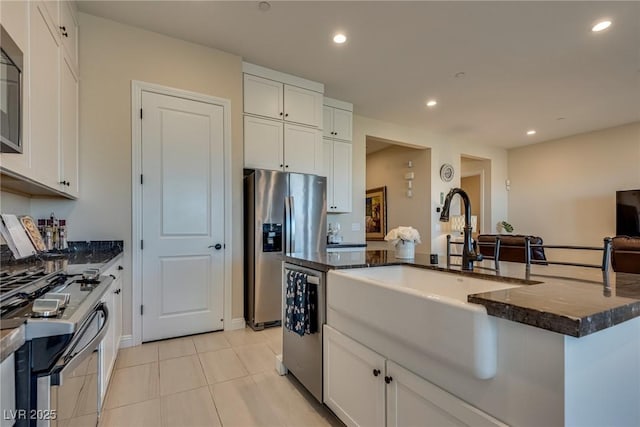 8944 Skye Canyon Ranch St, Las Vegas, NV 89166 - kitchen with stainless steel appliances, a sink, white cabinets, and recessed lighting