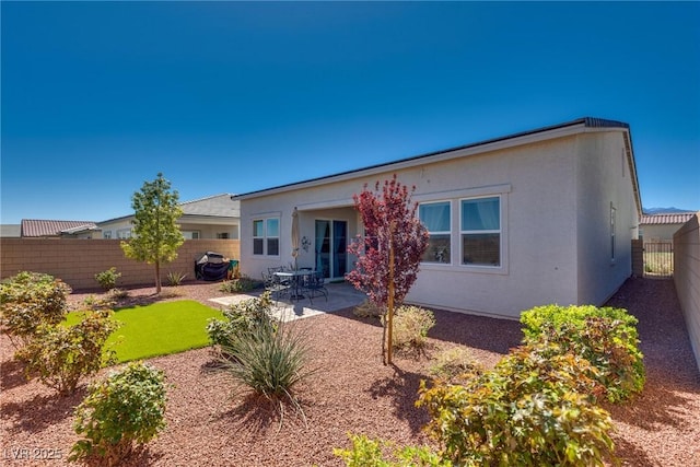8944 Skye Canyon Ranch St, Las Vegas, NV 89166 - back of house featuring a fenced backyard, a patio area, and stucco siding