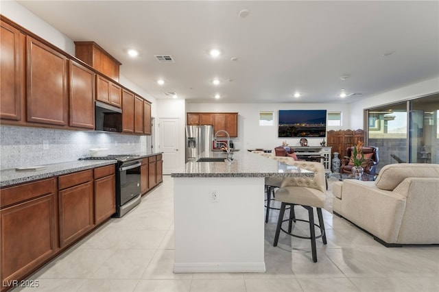 10216 Chrysolite Pl, Las Vegas, NV 89143 - kitchen featuring gas range oven, black microwave, stainless steel fridge with ice dispenser, open floor plan, and recessed lighting