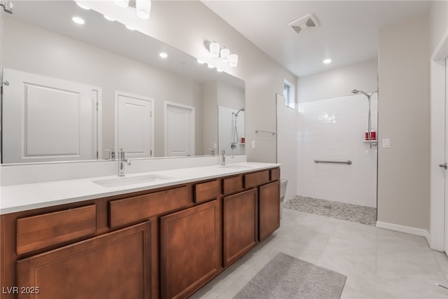 10216 Chrysolite Pl, Las Vegas, NV 89143 - bathroom featuring a walk in shower, double vanity, recessed lighting, and tile patterned flooring