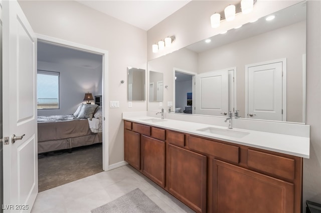 10216 Chrysolite Pl, Las Vegas, NV 89143 - full bathroom featuring ensuite bath, double vanity, tile patterned flooring, and baseboards