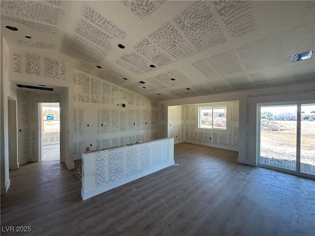 331 Huracan St, Pahrump, NV 89048 - interior space with wallpapered walls, baseboards, lofted ceiling, and wood finished floors