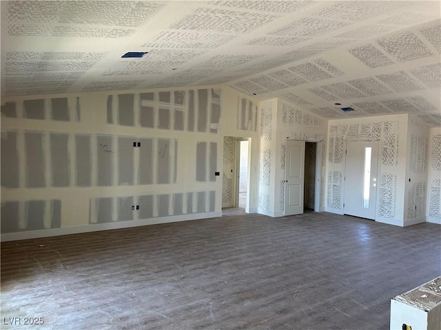 331 Huracan St, Pahrump, NV 89048 - unfurnished living room with baseboards, vaulted ceiling, and wood finished floors