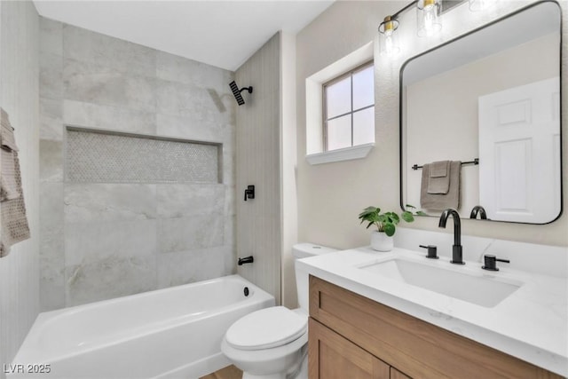 bathroom featuring toilet, vanity, and shower / tub combination