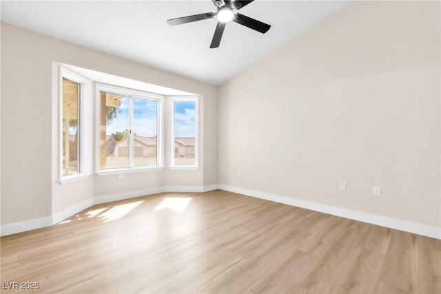 unfurnished room featuring baseboards, lofted ceiling, light wood-type flooring, and a ceiling fan