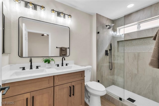 full bathroom featuring double vanity, a sink, toilet, and walk in shower
