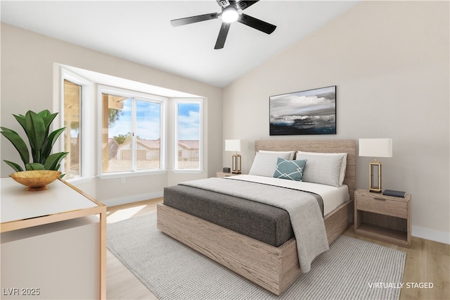 bedroom featuring baseboards, lofted ceiling, light wood-style floors, and a ceiling fan