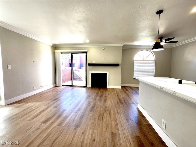 4050 Pacific Harbors Dr Unit 209, Las Vegas, NV 89121 - unfurnished living room with plenty of natural light, baseboards, ceiling fan, and wood finished floors