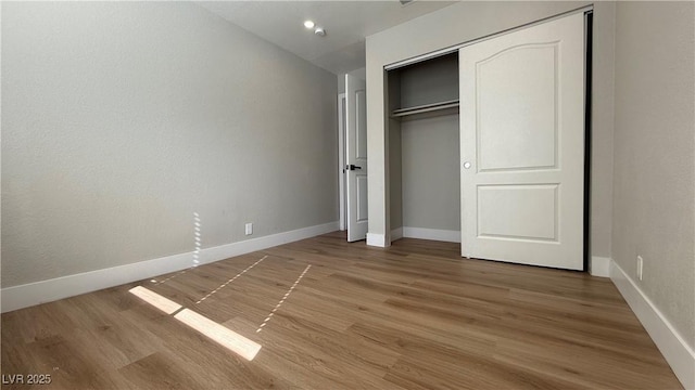4050 Pacific Harbors Dr Unit 209, Las Vegas, NV 89121 - unfurnished bedroom with baseboards, a closet, and light wood finished floors