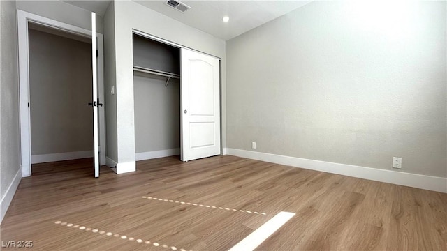 4050 Pacific Harbors Dr Unit 209, Las Vegas, NV 89121 - unfurnished bedroom with baseboards, visible vents, and light wood finished floors