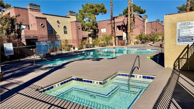 4050 Pacific Harbors Dr Unit 209, Las Vegas, NV 89121 - community pool with a community hot tub, a residential view, and fence
