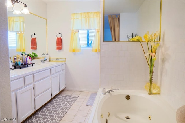 full bath featuring tile patterned floors, a healthy amount of sunlight, vanity, and a whirlpool tub