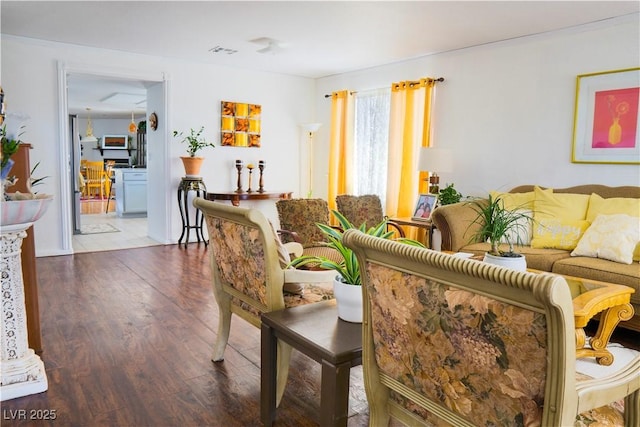 living room featuring visible vents and wood finished floors