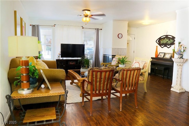 living room featuring dark wood-style flooring and ceiling fan