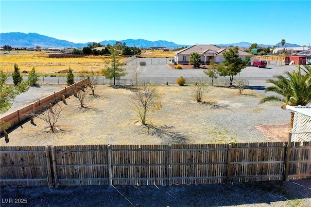 view of yard featuring a mountain view and a fenced backyard