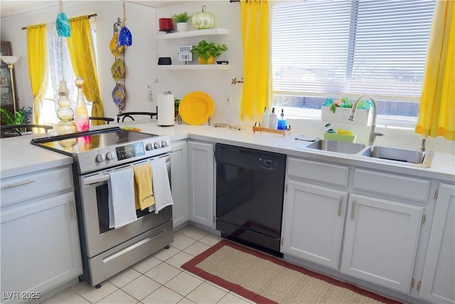 kitchen featuring light tile patterned floors, black dishwasher, a sink, light countertops, and stainless steel electric stove