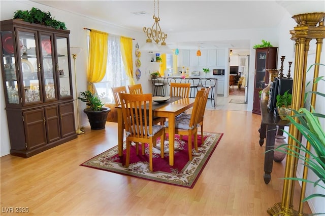 dining space with light wood-style flooring