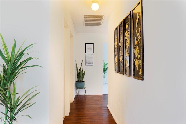 corridor with visible vents and wood finished floors