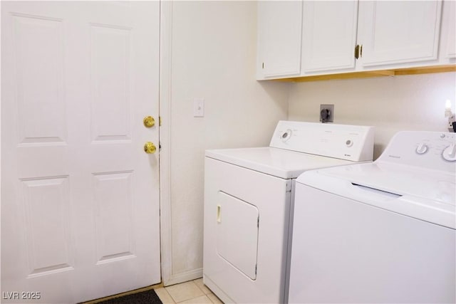 washroom featuring light tile patterned floors, separate washer and dryer, and cabinet space