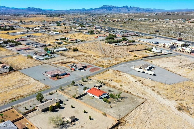 birds eye view of property featuring a mountain view and view of desert